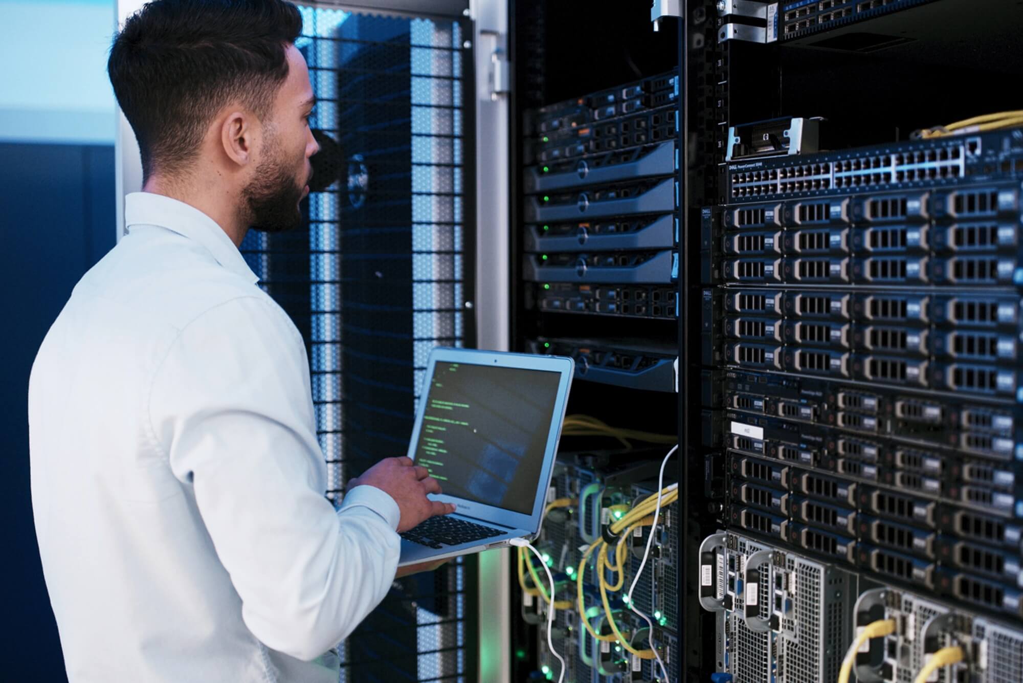 Man standing with laptop