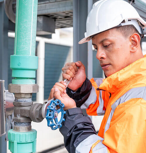worker-repairing-pipe-blue-valve-orange-jacket
