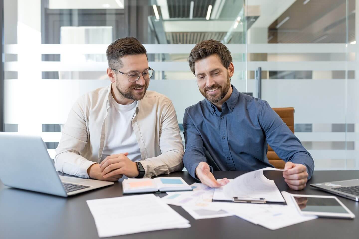 Minnesota business broker and client reviewing paperwork during a business sale transaction
